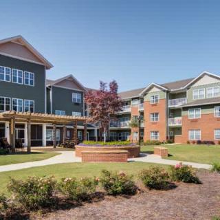 A view of a modern residential apartment complex with landscaped outdoor courtyard.