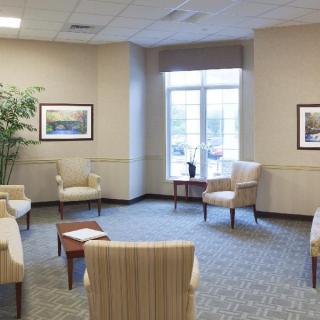A spacious waiting room with comfortable chairs and natural lighting.