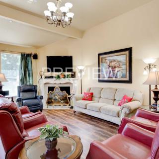 A cozy living room with comfortable seating, a fireplace, and elegant decor.