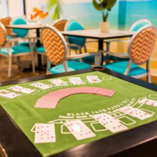 A casino card table with chairs in a lively indoor setting.