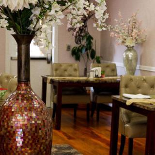 A cozy restaurant interior featuring elegant floral decor and neatly arranged tables.