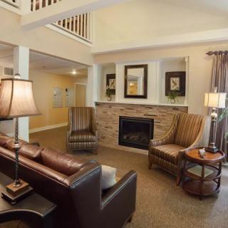 A cozy living room with a fireplace and comfortable seating.
