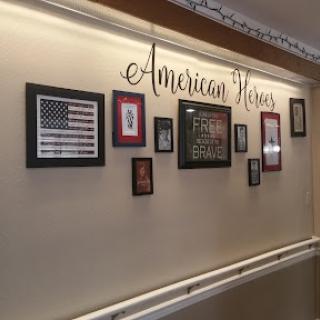 A collection of framed artworks celebrating American heritage displayed on a wall.