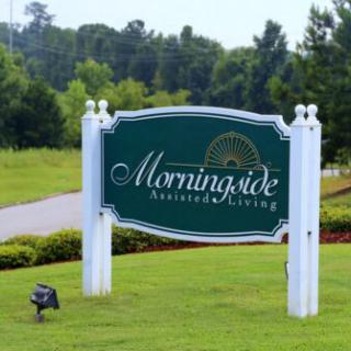 A sign for Morningside Residential Living situated in a lush, green landscape.