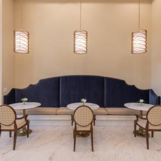 A minimalist dining area with elegant lighting and seating arrangement.