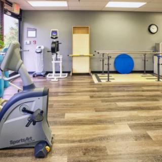 An indoor fitness center with a variety of exercise and rehabilitation equipment.