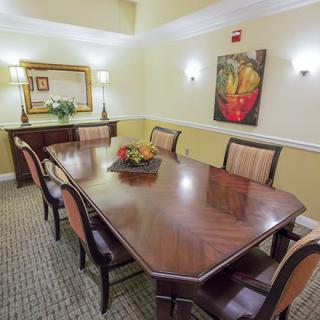 Elegant dining room with a polished table and stylish decor.