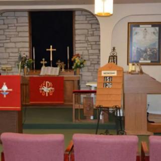 Interior view of a church sanctuary with an altar and pulpit.