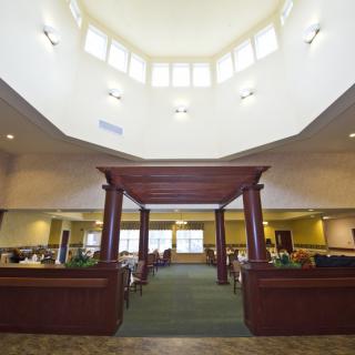 An elegant interior space with a high ceiling and structured seating area.