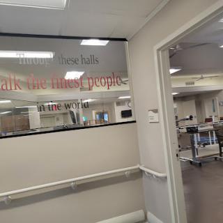 A view of a hospital corridor with a focus on signage indicating the area.