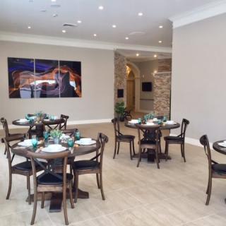 An elegant restaurant interior with neatly arranged tables and chairs.