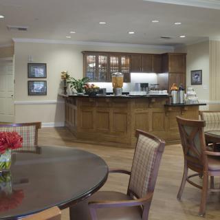 A cozy kitchen and dining area with wooden furniture and modern lighting.