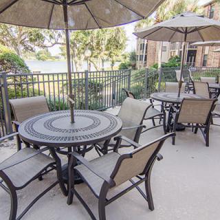 Outdoor patio area with tables, chairs, and umbrellas for relaxation.