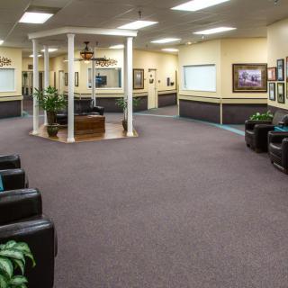 A spacious waiting area with comfortable seating and decorative accents.