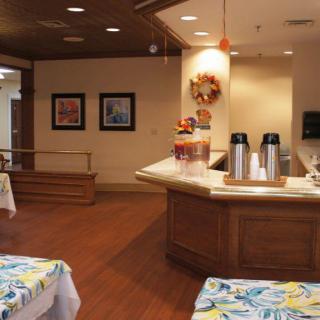 A cozy cafe interior with a coffee station and autumn decorations.