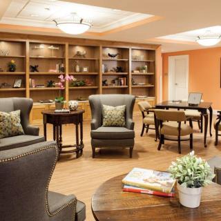 A cozy living room with comfortable seating and bookshelves, perfect for relaxing and reading.