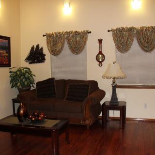 A cozy living room with a sofa, coffee table, and elegant decor.