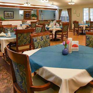 Elegant dining room with neatly set tables and comfortable seating.