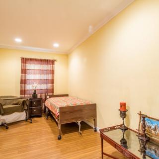 A cozy bedroom with two beds, a nightstand, and decorative items.