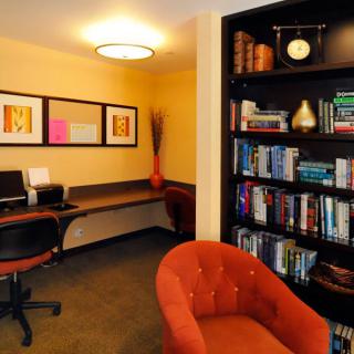 A cozy office space featuring a computer desk and a well-stocked bookshelf.