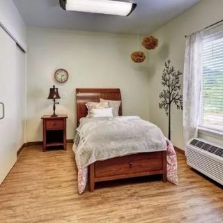 A cozy bedroom with a single bed and elegant decor.
