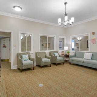 A spacious living room with comfortable seating and stylish lighting.