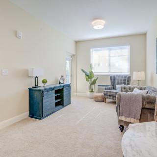 A modern and minimalist living room featuring a sofa, stylish decor, and ample natural light.