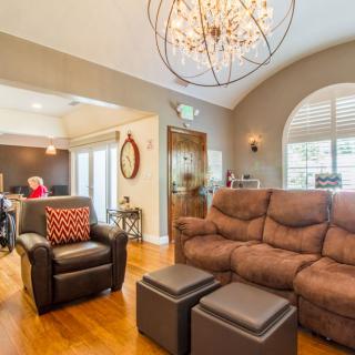 A cozy living room featuring comfortable seating, elegant lighting, and stylish decor.