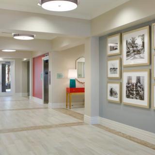 A modern hallway with framed artwork and contemporary lighting.