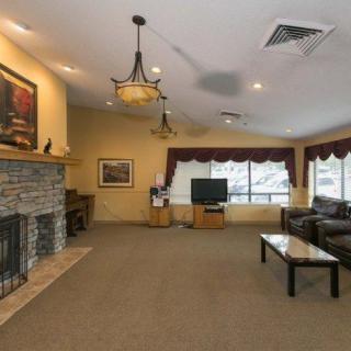 Spacious living room with a fireplace, TV, and comfortable seating area.