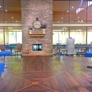 Spacious lobby area with a central fireplace and decorative clock.
