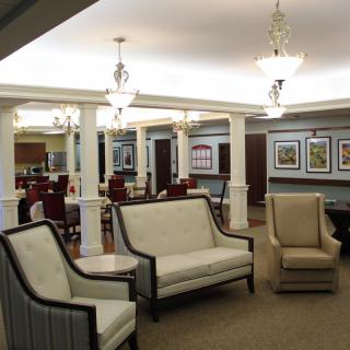 A well-lit lounge area with comfortable seating and decorative artwork on the walls.