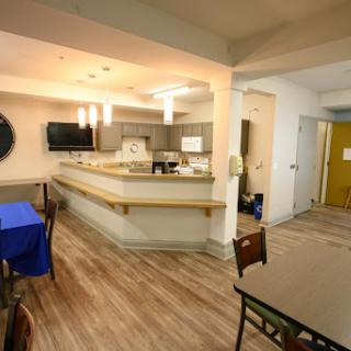 A modern kitchen and dining area featuring an open layout with wooden flooring.