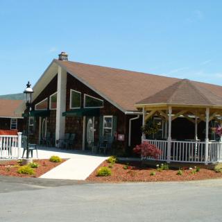 A scenic view of a building with a gazebo and well-maintained landscaping.