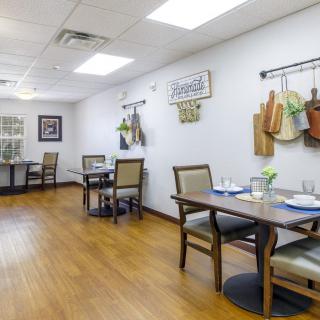 A cozy dining area with neatly arranged tables and decorative wall items.