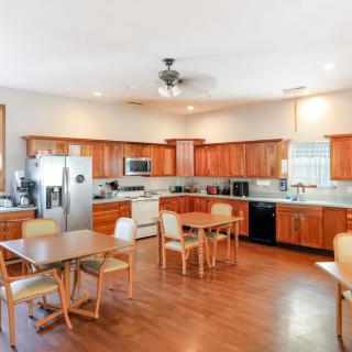 Spacious kitchen and dining area with wooden cabinets and modern appliances.