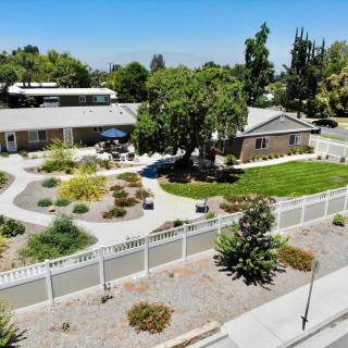 Aerial view of a well-maintained house with a landscaped yard and garden.