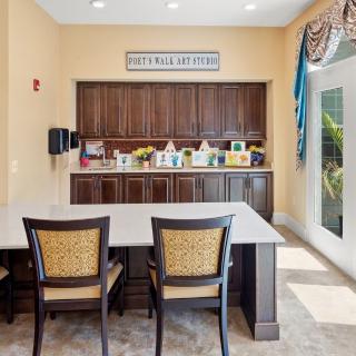 A cozy cafe area featuring a coffee station with seating and a bright, inviting atmosphere.