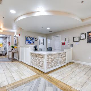 A modern reception desk in a well-lit office lobby.