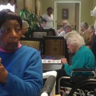 Residents of a care facility engaging in daily activities.