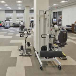 A spacious fitness center equipped with various exercise machines.