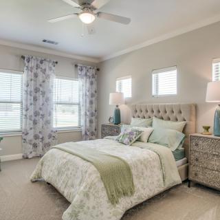 A cozy and well-decorated bedroom with soft lighting and neutral colors.