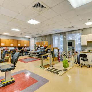 A well-equipped physical therapy room featuring exercise stations and rehabilitation tools.