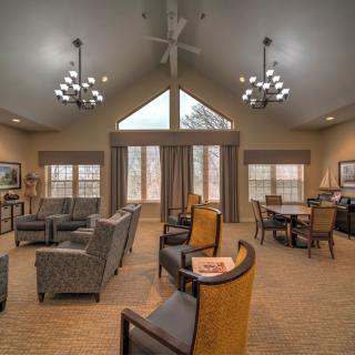 A spacious living room with comfortable seating and large windows.