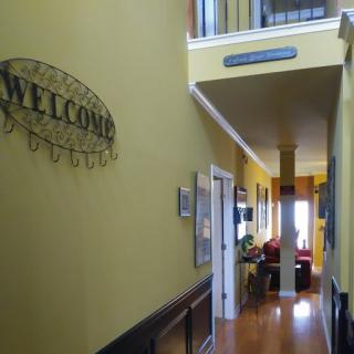 A warmly lit hallway featuring a 'Welcome' sign and decorative elements.