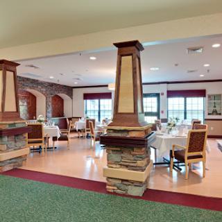 A spacious and inviting dining area featuring elegant furniture and decorative architectural elements.
