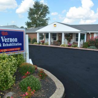 The exterior of a nursing and rehabilitation center, featuring a welcoming entrance and well-maintained landscaping.