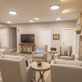 A cozy modern living room with comfortable seating and a television.