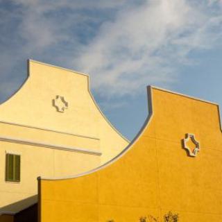 An architectural facade with unique designs against a clear sky.