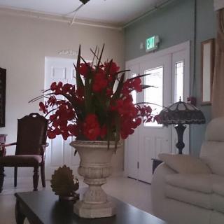 A cozy living room with a vibrant flower arrangement in the center.